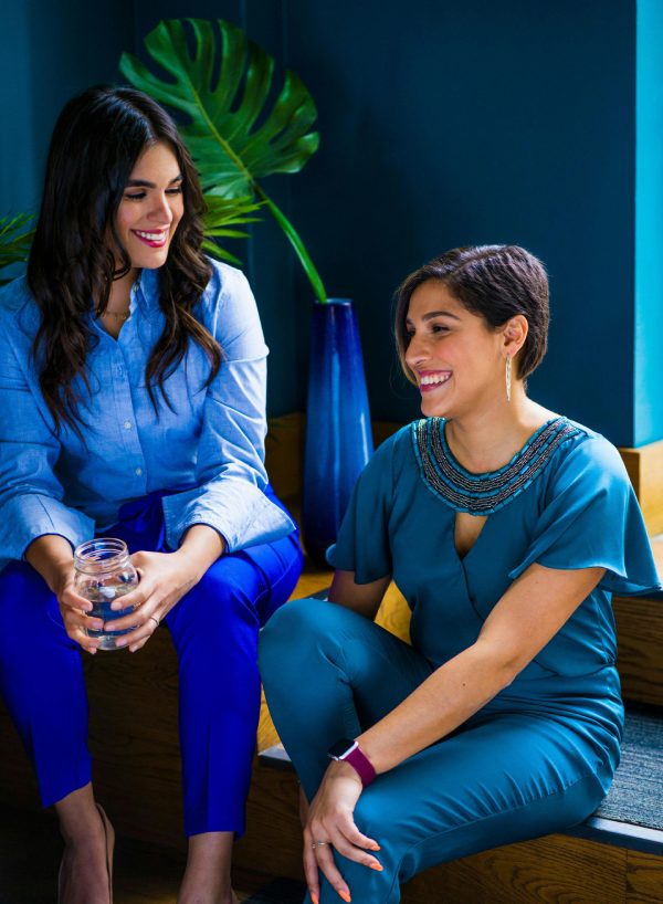 dos mujeres de azul amigas compañeras de trabajo colegas