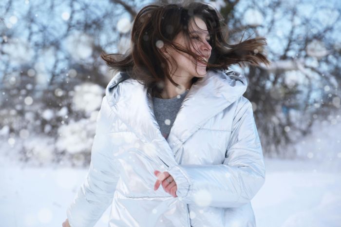 Mujer con abrigo acolchado en la nieve