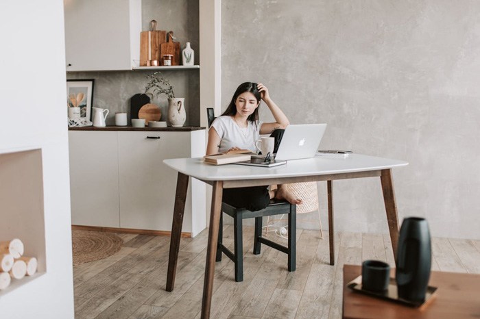 mujer sentada en una silla estudiando frente al ordenador